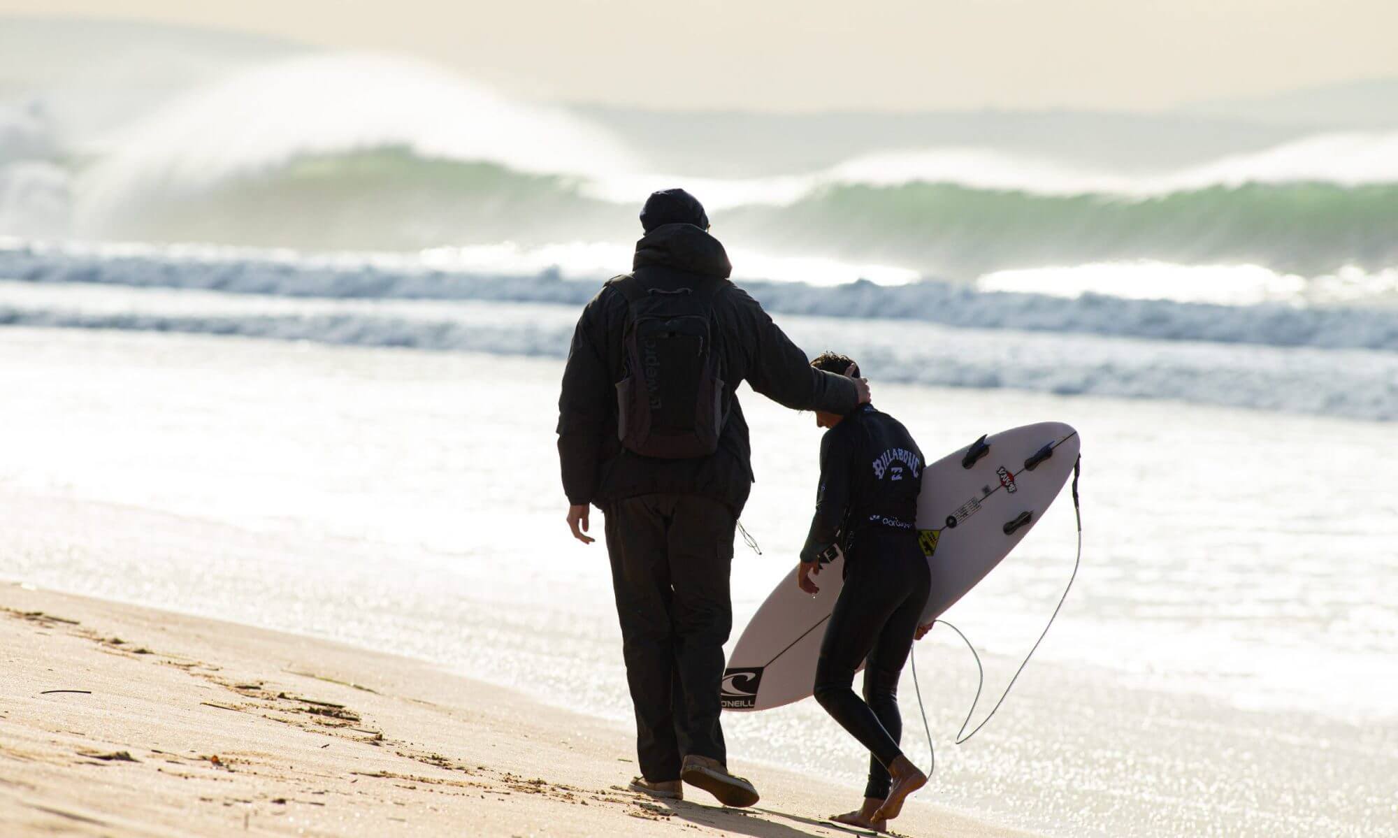 Family Fun at the Beach: Father and Kid Surfing